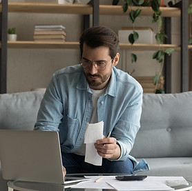 business man looking at the screen focused on his budget, how much he saved
