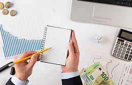 Marketing professionals using cost analysis charts and ROI optimization tools for strategic budgeting in digital campaigns